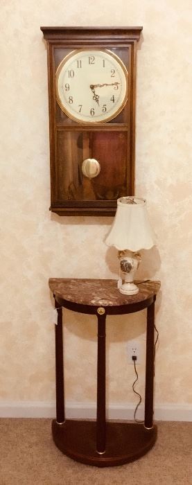 Beautiful Oval Marble Table with a single Lamp. Elegant but stylist for this space at the end of a long hallway.