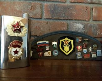 Some vintage Russian Army items he collected while in Russia. Russian Army hat & flask & Russian political pins on the cap.