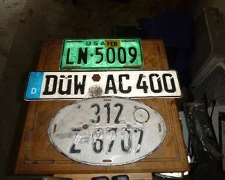 several vintage European car tags, the green one is a NATO tag