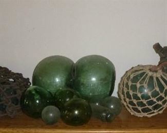 Vintage Japanese glass fishing net floats, including hard to find binary glass float, some have Maker's Marks. The largest one measures 37" in diameter.