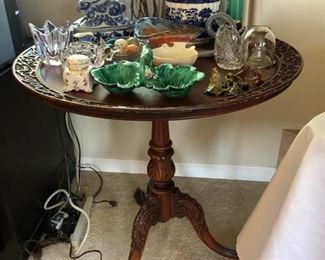 Antique pie crust table with intricate carving.