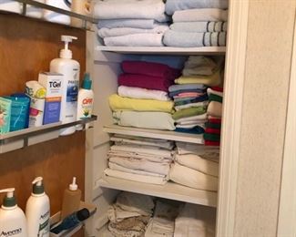 Closet full of towels, sheets and bathroom items.