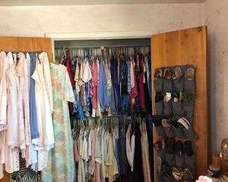 One of 3 closets full of ladies clothes and shoes.