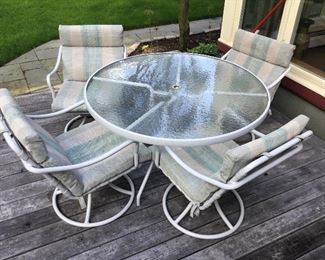 Glass circular patio table and 4 swivel chairs