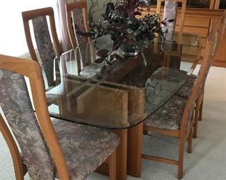 Glass and Teak dining room table with 6 armless chairs