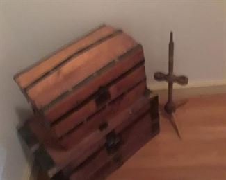 Doll trunk on top of larger trunk, both with metal strapping