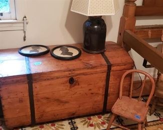 Old trunk with metal strapping  silhouettes, doll chair and more