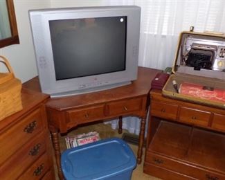vintage Sewing Machine in original Case, older TV that works, corner Table, two drawer Table, Basket's