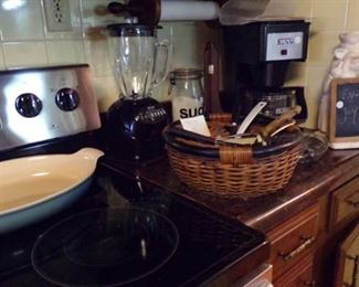 large serving Dish, Basket of misc items, Blender, Bunn Coffee Maker, Pig Statue Chalk message Board