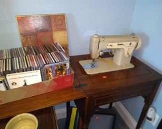 CDs and Singer sewing machine in cabinet