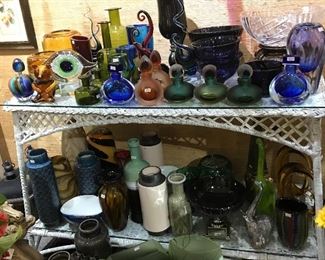 Art glass decanters, pottery vases, wicker shelving