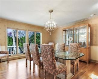 Beveled edge dining table with 8 upholstered chairs. Two arm chairs, 6 side.