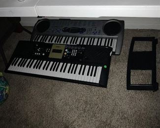 Casio and Yamaha keyboards with stands