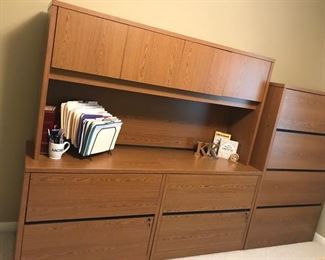 Two piece L-shaped medium oak desk (Piece against wall is 48"Kx24"Dx29"H and return is 30"Wx68"Lx29H) 
Four drawer filing cabinet (36" W x 20" D x 59"H)  (Shown to the left of the lateral files)
Two Matching lateral files medium oak (36"Wx29"Hx"29H each)
Hutch above fiing cabinet smedium oak (44 3/4" W x 24"Dx29"H
Bookcase (36"W x 13" D x67 3/4" H_
Chair 