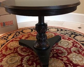 Classic round pedestal entry table with lovely 6’ round entry rug in red & black. 