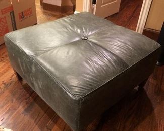 Super green leather ottoman can double as a coffee table.  
