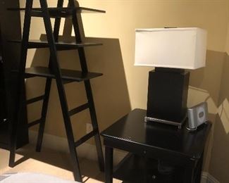 Ladder shelving, side table & rectangular table lamp add dimension to bedroom suite. 