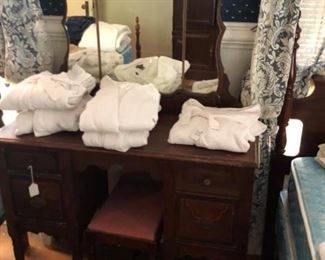 Old dressing table with stool
And white robes. 