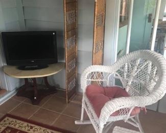 White wicker chair, tv and stand. 
Rugs, wicker stand 