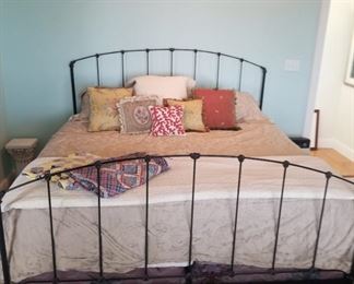 King size iron bed, decorative tapestry and needlepoint pillows