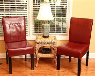 Pair of faux leather chairs with wicker table.