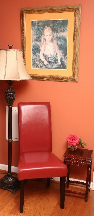 One of a pair of faux leather chairs next to  a low Chinese table.