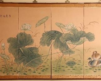 Oriental screen mounted on wall.