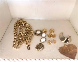 Gold Tone and White Background Jewelry