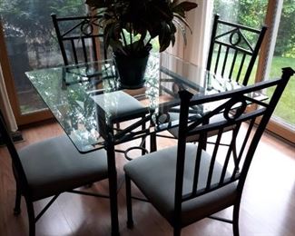 Heavy beveled glass table and wrought iron chairs