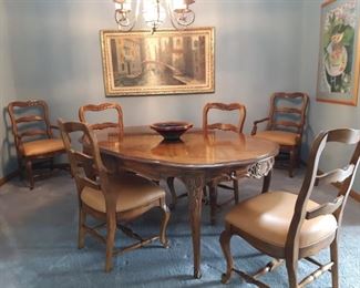 Beautiful dining table 6 chairs.  Seating leather and clean.  Heritage House.  Excellent condition.  2 extensions