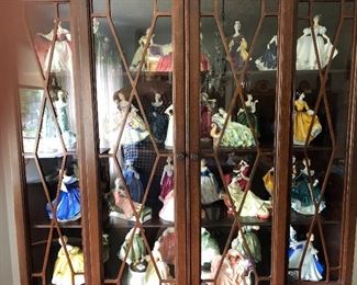 About 100 Royal Doulton figurines in 3 different cabinets