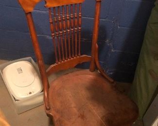 Invisible monarch sitting in an antique comb-back chair