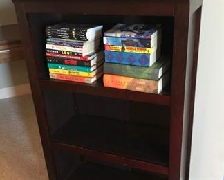 Small brown wood book shelf and kids books