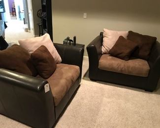 Two-tone sofa with tan / brown pillows and pair of matching chairs