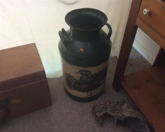 Milk can with ducks on it.