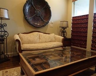 Large Wooden Table with Glass Top. Large Metal Mosaic Decorative Piece. Metal Lamps.