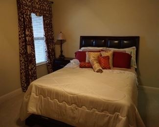 Full Sized Bed with Drapes. Bedroom Nightstand and Lamp.