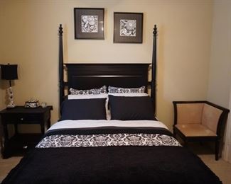 Full Sized Modern Bed with Modern Bedroom Furniture and Artwork.