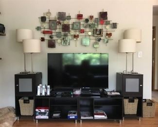 Metal Abstract Wall Art, Ikea Lamps, Modular Entertainment Center, Vizio E50-C1 50 in Flatscreen, ATT phone set, Baskets.