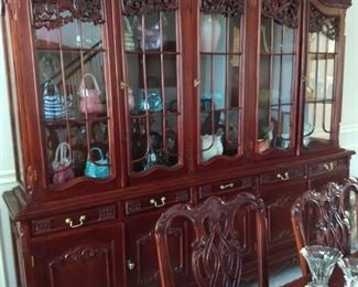 large display cabinet with glass handbag collection
