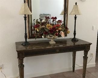 marble top console table, wall mirror, faux floral and buffet lamps