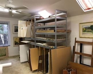 Shelving and artist supplies including foam core, sanded paper, glass, metal frame kits