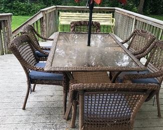 Wicker patio table with 6 chairs and umbrella