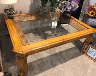 Carved wooden coffee table with glass top