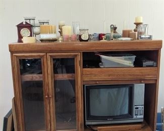 entertainment center and candles of all sizes