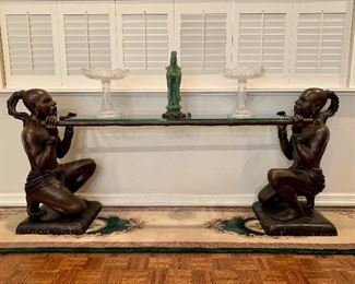 This Exquisite Sculpture signed CM Clodion is currently used as a console table. It depicts two servants holding a litter and was possibly a part of a larger grouping by the artist Claude Michel (1738-1814) who worked under the name Clodion.