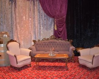 ornate  purple couch with pink arm chairs