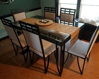 Glass and metal dining table with 6 matching upholstered chairs.