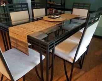 Metal and glass dining table with 6 matching upholstered chairs.