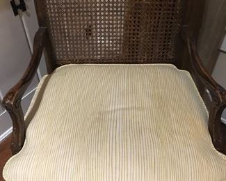 French wooden arm chair, hole caning, with yellow striped cushion